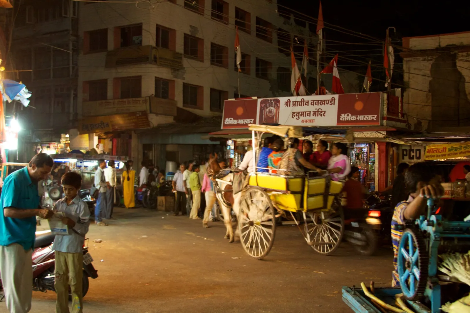 Mixed traffic in an Indore market at night